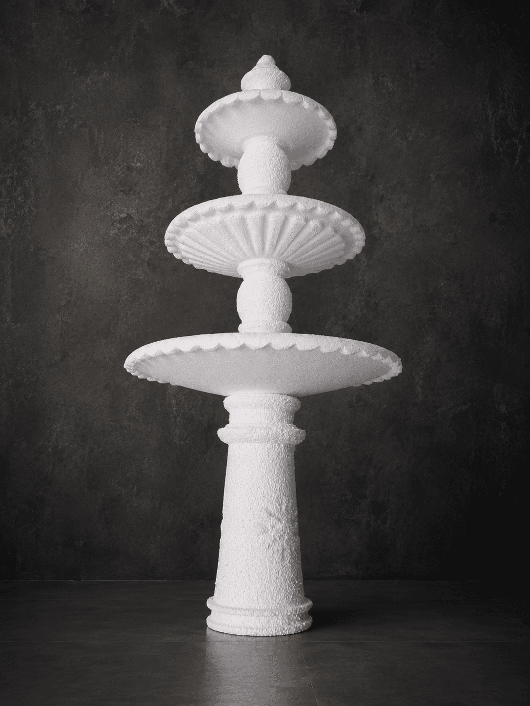 Tall white classical tiered fountain with shell-like bowl details