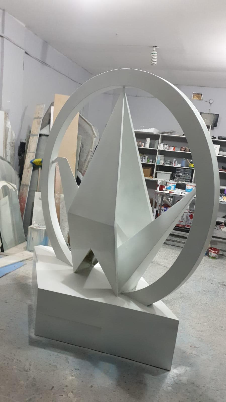 Abstract faceted sculptural form displayed in a workshop interior